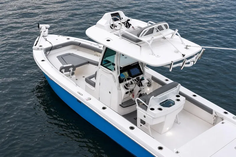 Slide: The Image of 2024 Everglades 253 Center Console boat on water, featuring modern design and advanced navigation systems. - 38