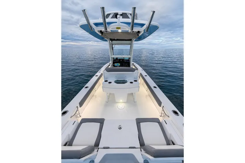 Slide: The Image of 2024 Everglades 253 Center Console boat on calm ocean waters, showcasing sleek design. - 39