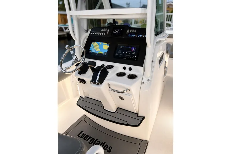 Slide: The Image of 2024 Everglades 253 Center Console boat dashboard with navigation and control systems. - 42