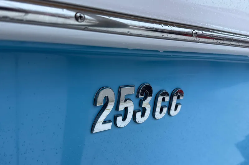 Slide: The Image of Close-up of 2024 Everglades 253 Center Console boat emblem on blue hull. - 44