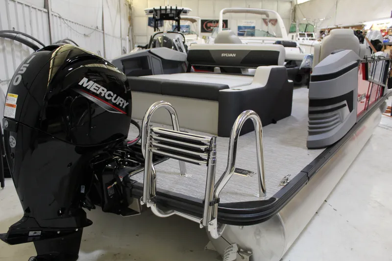 Slide: The Image of 2026 Sylvan R-22 CLZ DH pontoon boat with Mercury engine in a showroom. - 2