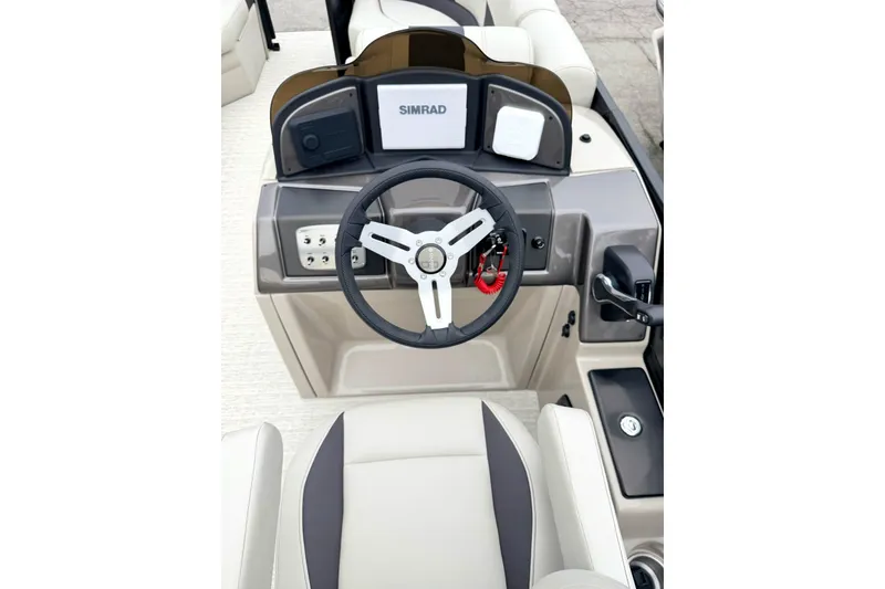 Slide: The Image of 2026 Coach Pontoons 223 RFC helm with Simrad display and modern steering wheel. - 10