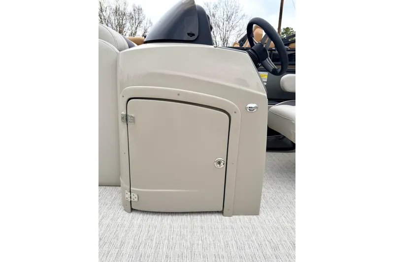 Slide: The Image of 2026 Coach Pontoons 223 RFC helm station with storage compartment and steering wheel. - 12