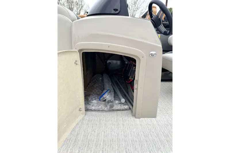 Slide: The Image of Storage compartment of 2026 Coach Pontoons 223 RFC, showcasing interior space and materials. - 13