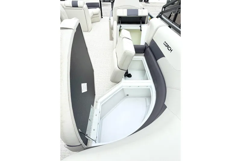 Slide: The Image of 2026 Coach Pontoons 223 RFC boat interior with open storage compartment. - 9