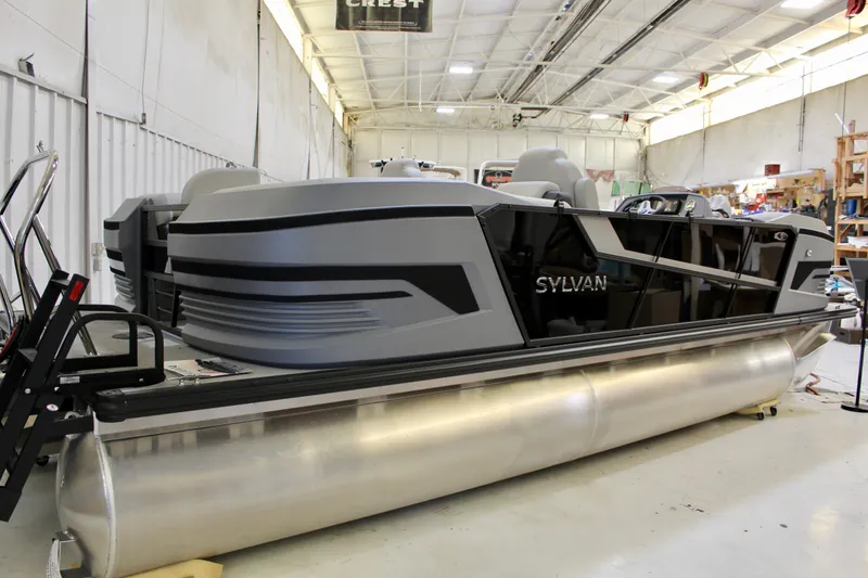 Slide: The Image of 2026 Sylvan R-22 LZ DH pontoon boat in a workshop. - 2