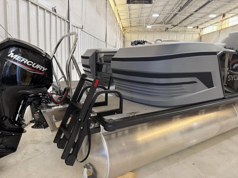 Slide: The Image of Sylvan R-22 LZ DH 2026 pontoon boat with Mercury engine in warehouse. - 3