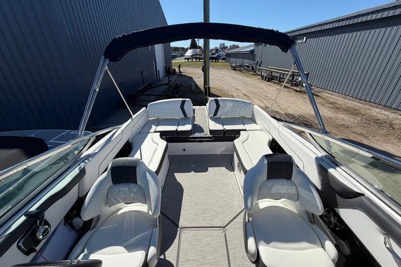 Slide: The Image of 2019 Regal 2300 Bowrider boat interior with white seating and canopy. - 14