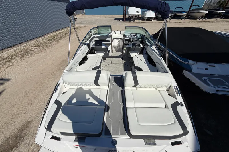 Slide: The Image of 2019 Regal 2300 Bowrider boat with spacious seating and sleek design, docked outdoors. - 5
