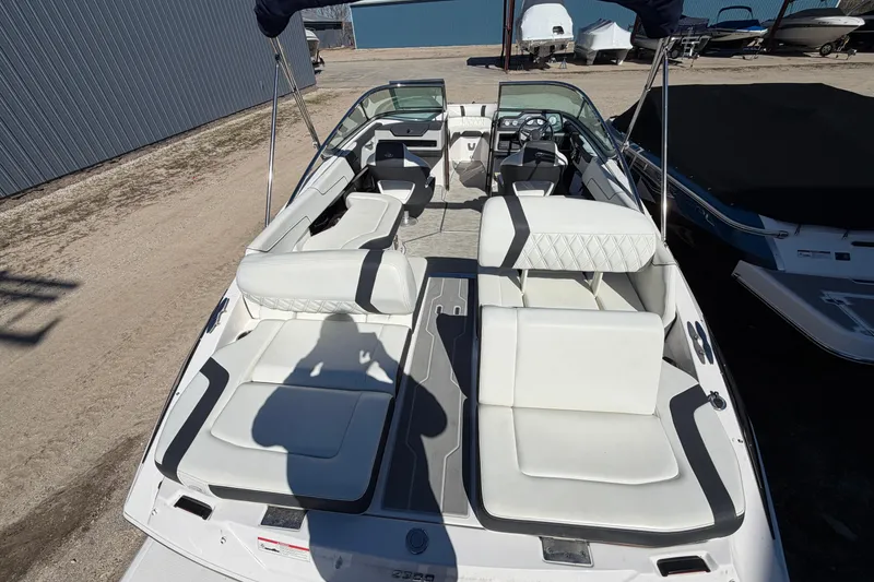 Slide: The Image of 2019 Regal 2300 Bowrider boat with spacious white seating and modern design. - 6