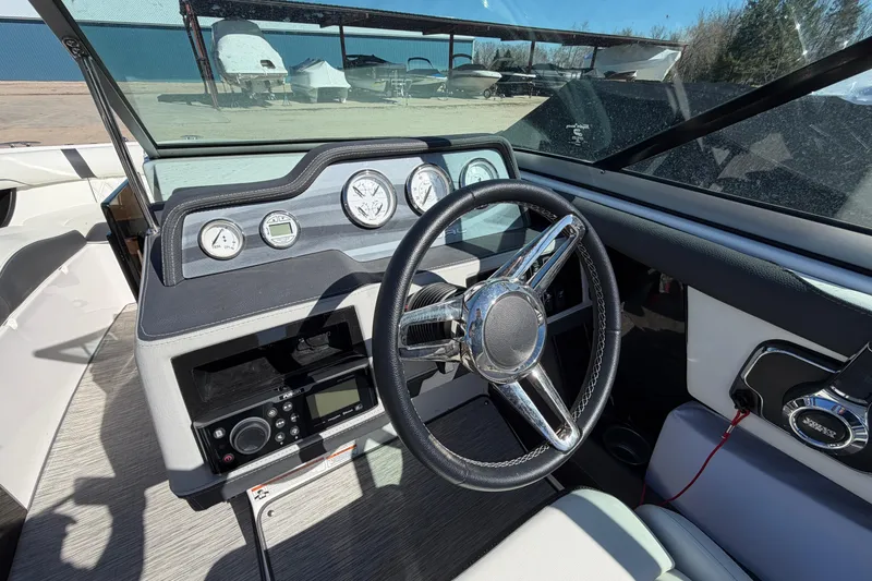 Slide: The Image of 2019 Regal 2300 Bowrider dashboard with steering wheel and control panel. - 9
