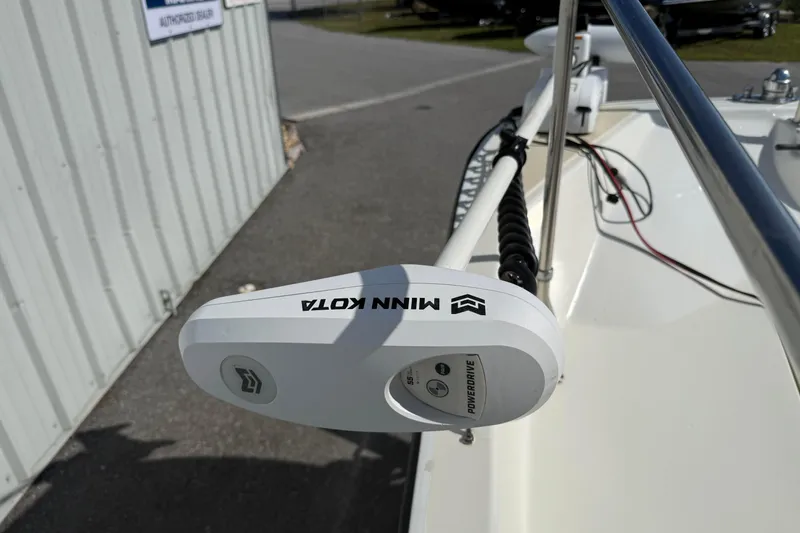 Slide: The Image of Minn Kota PowerDrive motor on 1978 Boston Whaler 17 Montauk boat, docked near a building. - 12