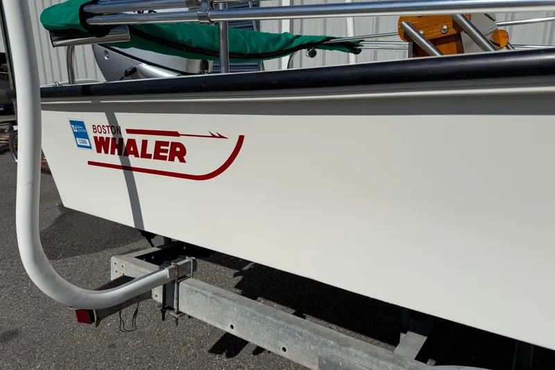 Slide: The Image of 1978 Boston Whaler 17 Montauk boat on trailer, showcasing logo and hull details. - 2