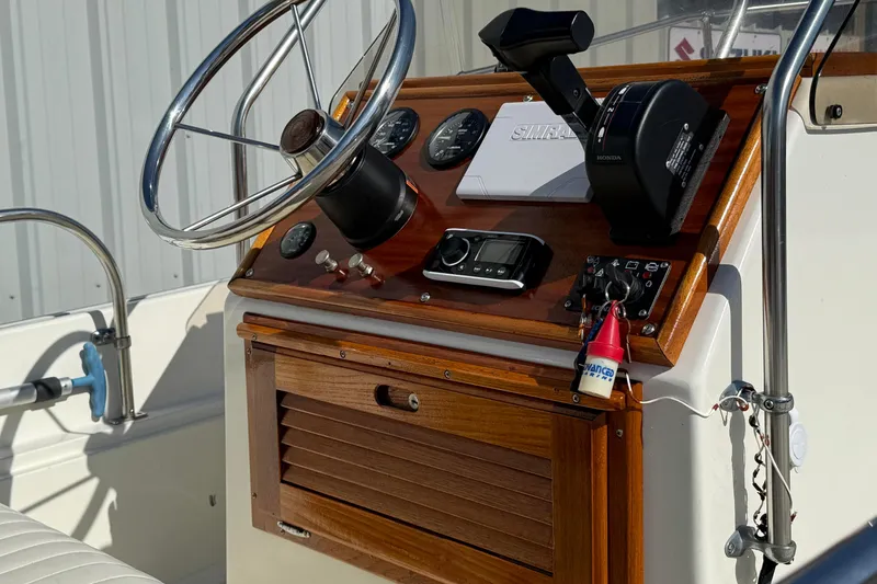 Slide: The Image of 1978 Boston Whaler 17 Montauk boat dashboard with steering wheel and controls. - 3