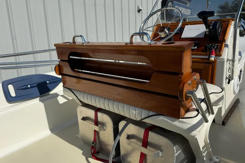 Slide: The Image of 1978 Boston Whaler 17 Montauk boat interior with wooden console and steering wheel. - 4