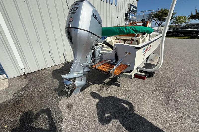 Slide: The Image of 1978 Boston Whaler 17 Montauk with Honda 90 outboard motor, parked outdoors. - 5