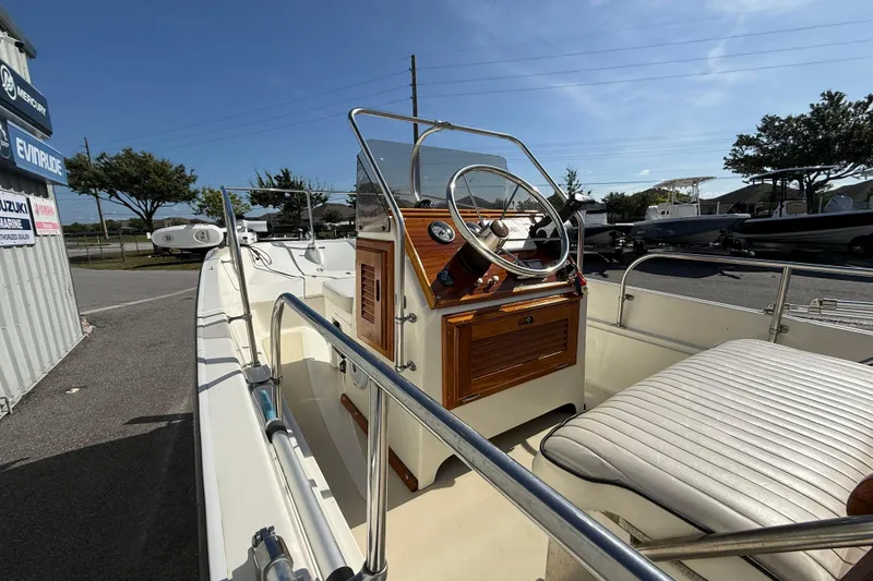 Slide: The Image of 1978 Boston Whaler 17 Montauk boat interior with steering wheel and seating. - 6