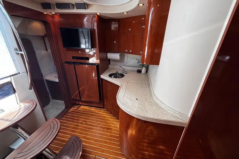 Slide: The Image of Luxurious 2006 Regal Commodore 3860 yacht interior with elegant wood finishes and modern amenities. - 10