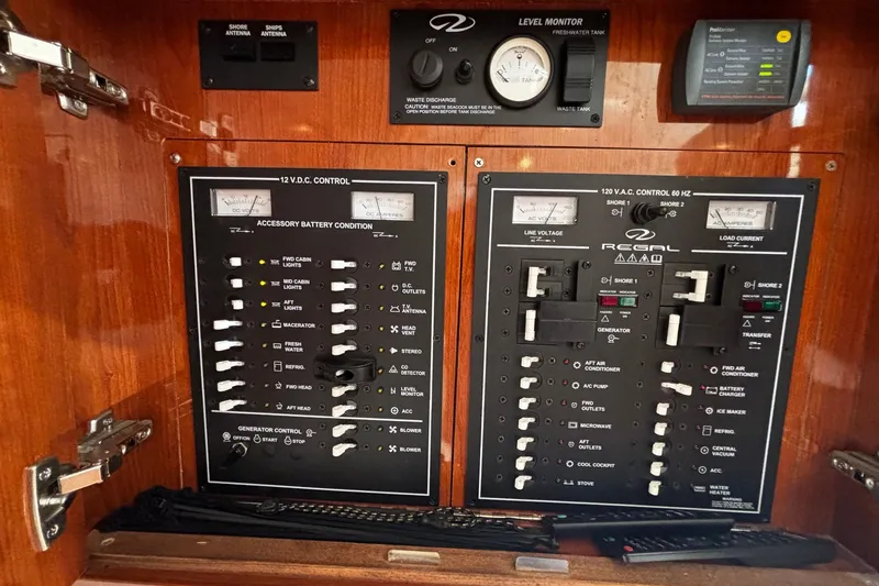 Slide: The Image of Electrical control panel of 2006 Regal Commodore 3860 yacht, featuring various switches and gauges. - 13