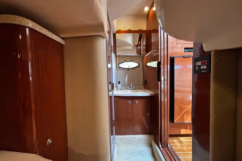 Slide: The Image of Interior of 2006 Regal Commodore 3860 yacht with wooden cabinetry and compact sink area. - 18