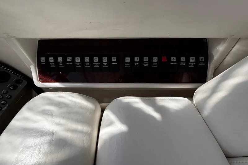 Slide: The Image of Control panel of a 2006 Regal Commodore 3860 boat with labeled switches. - 21
