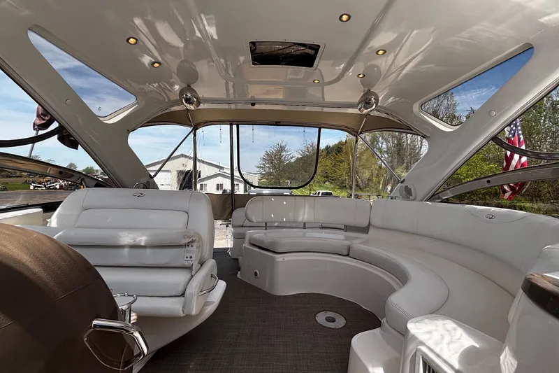 Slide: The Image of Luxurious interior of 2006 Regal Commodore 3860 yacht with plush seating and panoramic windows. - 27