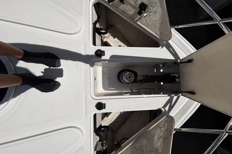 Slide: The Image of 2006 Regal Commodore 3860 yacht deck with open storage compartments and visible anchor mechanism. - 32