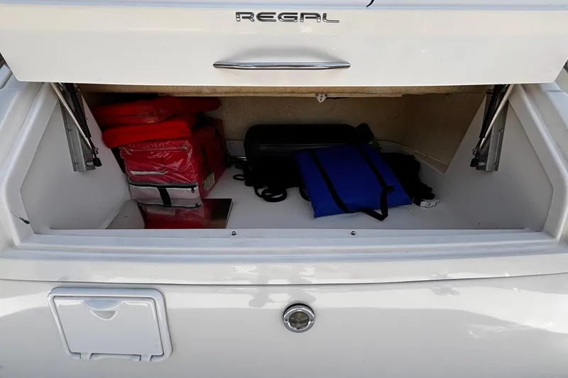Slide: The Image of Storage compartment of 2006 Regal Commodore 3860 boat with life jackets and bags. - 34