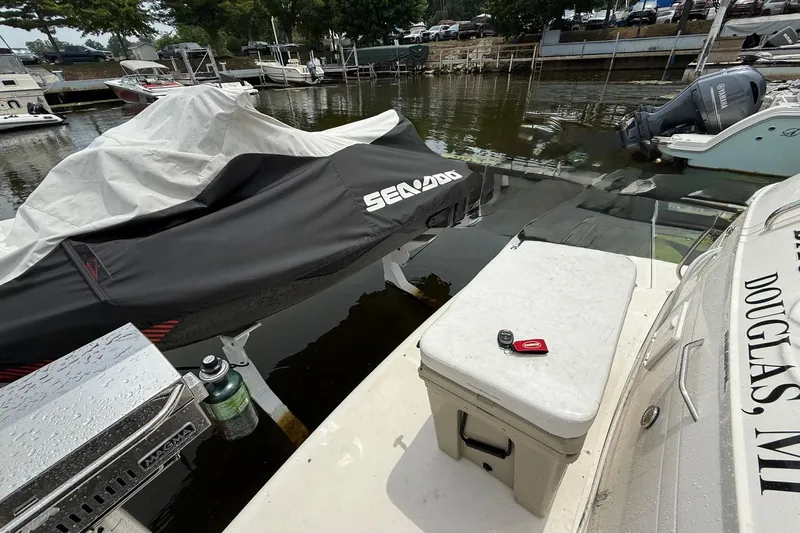 Slide: The Image of Docked Regal Commodore 3860 boat with covered Sea-Doo, marina background, 2006 model. - 36