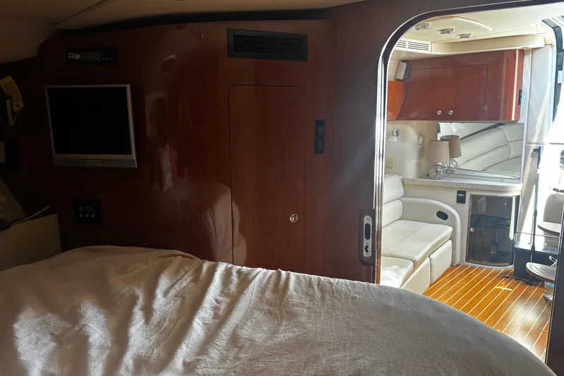 Slide: The Image of Interior of 2006 Regal Commodore 3860 yacht with wood paneling and cozy seating area. - 4