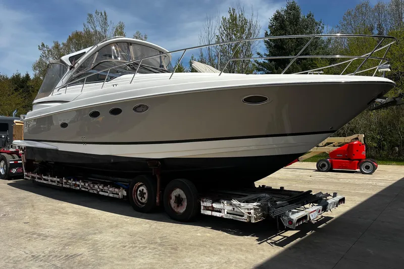 Slide: The Image of 2006 Regal Commodore 3860 yacht on trailer, outdoors, with trees in background. - 40