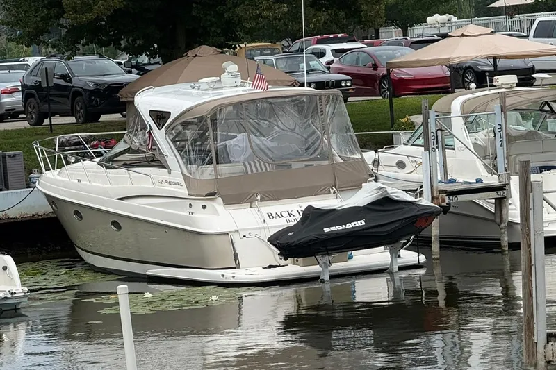 Slide: The Image of 2006 Regal Commodore 3860 yacht docked with covered jet ski nearby. - 50
