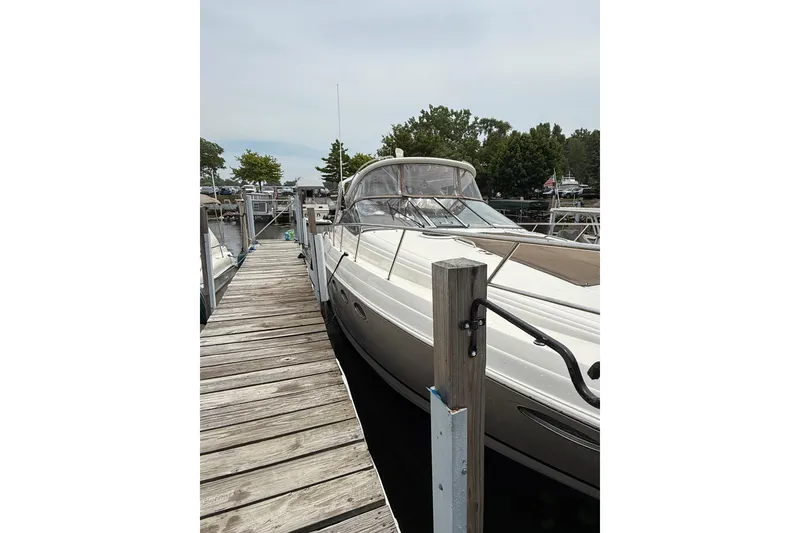 Slide: The Image of 2006 Regal Commodore 3860 yacht docked at a marina with wooden pier. - 52