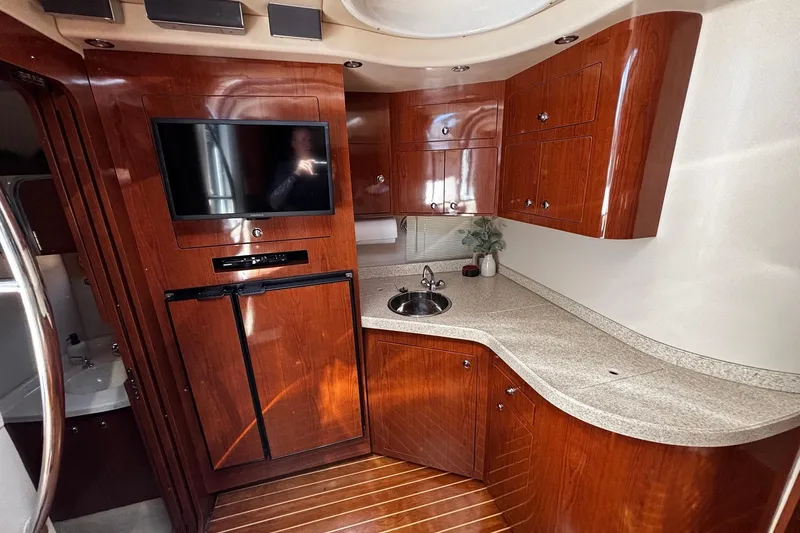 Slide: The Image of Luxurious 2006 Regal Commodore 3860 yacht interior with wood cabinetry and modern amenities. - 7