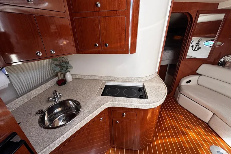 Slide: The Image of Luxurious 2006 Regal Commodore 3860 yacht interior with modern kitchen and elegant wood finishes. - 9