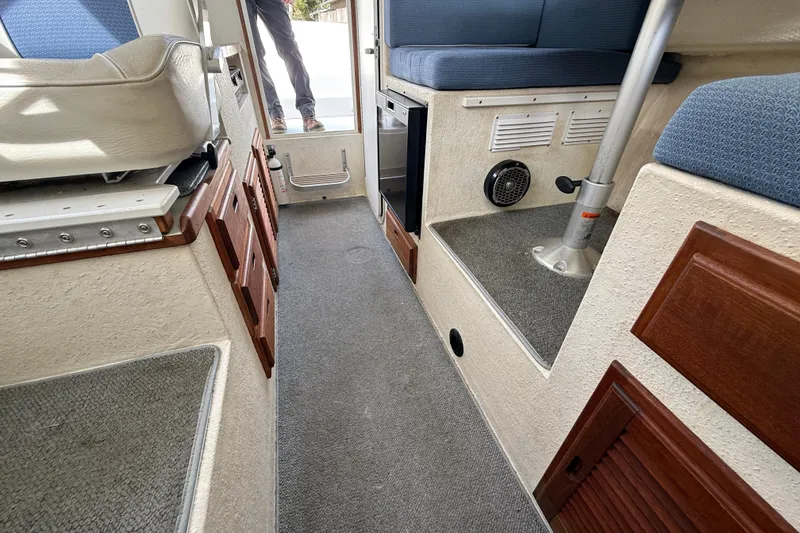 Slide: The Image of Interior of 2005 SeaSport Explorer 2400 boat with seating and storage. - 11