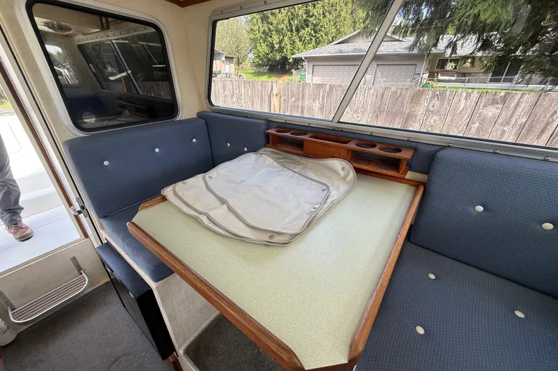 Slide: The Image of Interior of 2005 SeaSport Explorer 2400 boat with seating and table. - 12