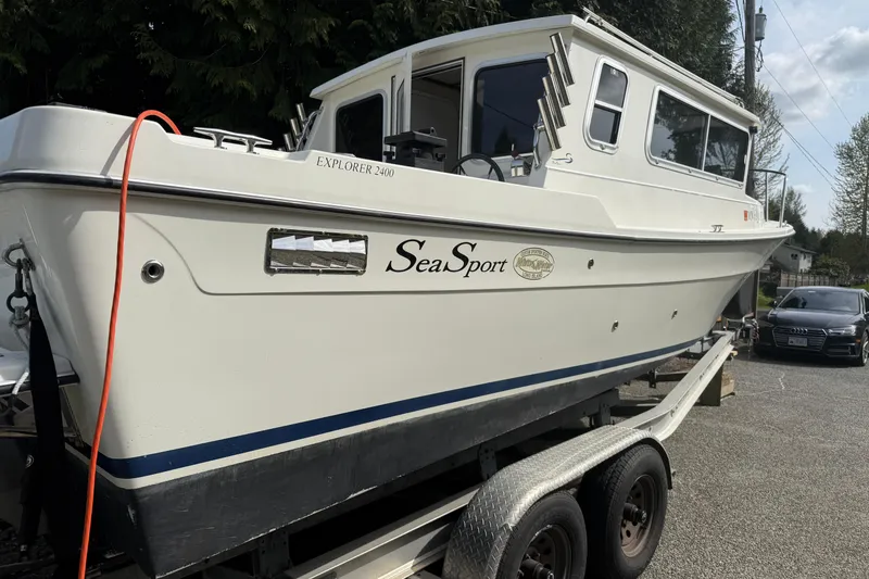 Slide: The Image of 2005 SeaSport Explorer 2400 boat on trailer, side view with visible branding. - 5