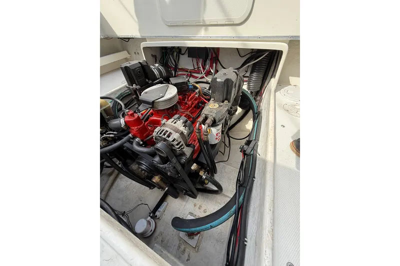 Slide: The Image of Engine compartment of a 2005 SeaSport Explorer 2400 boat, showcasing mechanical components. - 8