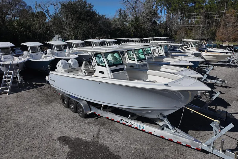 The Image of 2026 Sailfish 272 CC boat on trailer in a marina lot. - 0