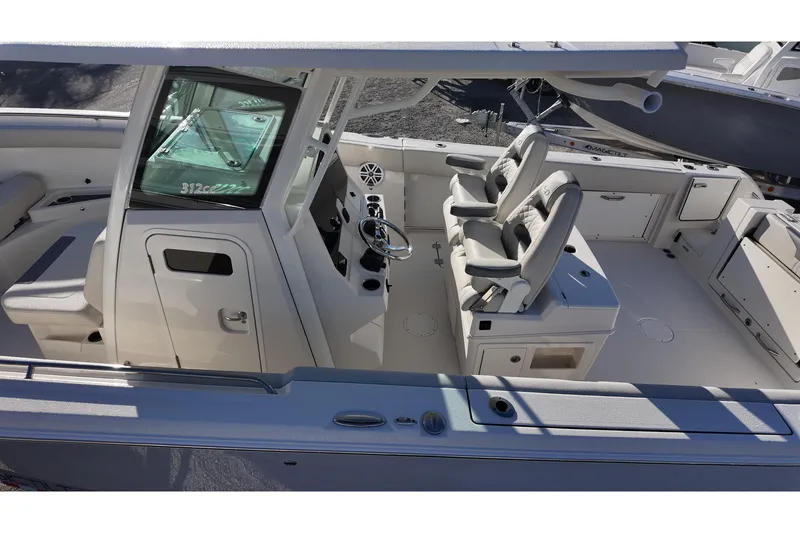 Slide: The Image of 2026 Sailfish 272 CC boat interior with dual captain seats and modern helm. - 11