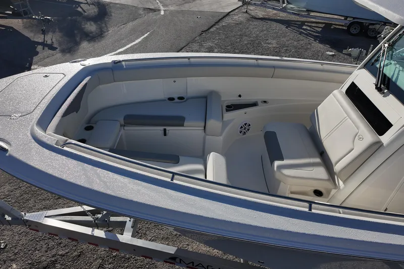 Slide: The Image of 2026 Sailfish 272 CC boat interior with cushioned seating and cup holders. - 12