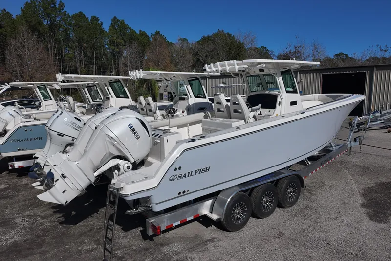 Slide: The Image of 2026 Sailfish 272 CC boat with Yamaha engine on a trailer, parked outdoors. - 2