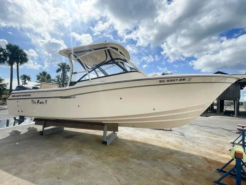 The Image of 2015 Grady-White Freedom 275 boat on display under a partly cloudy sky. - 0