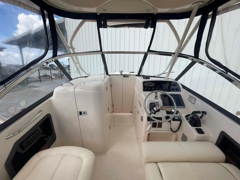Slide: The Image of 2015 Grady-White Freedom 275 boat interior with steering wheel and seating. - 10
