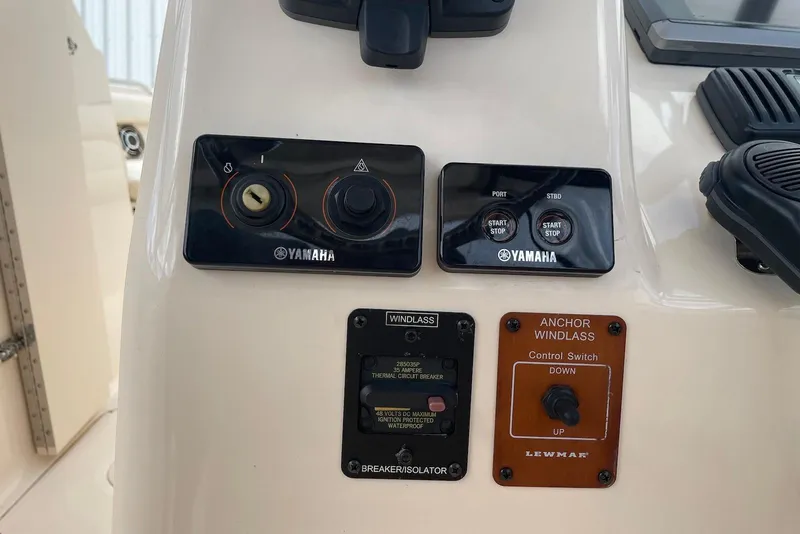 Slide: The Image of Control panel of a 2015 Grady-White Freedom 275 boat with Yamaha and Lewmar switches. - 12
