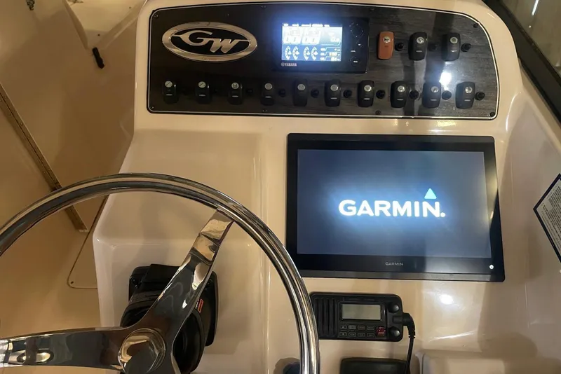 Slide: The Image of 2015 Grady-White Freedom 275 dashboard with Garmin display and steering wheel. - 13