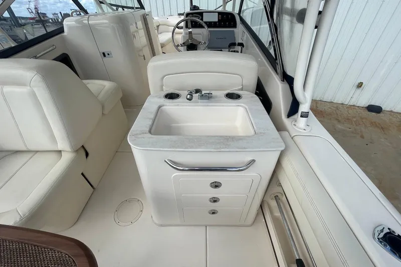 Slide: The Image of 2015 Grady-White Freedom 275 boat interior with sink and seating area. - 17