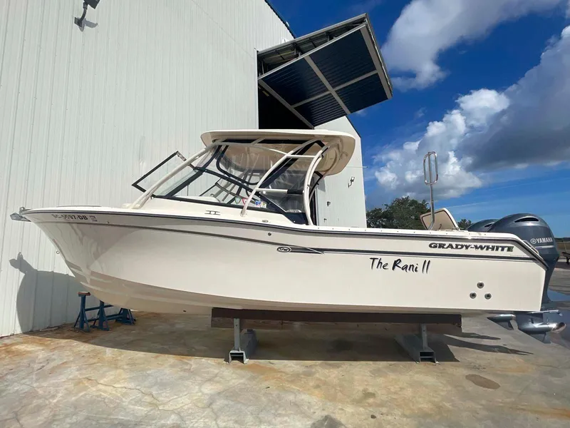Slide: The Image of 2015 Grady-White Freedom 275 boat on display under a clear blue sky. - 2