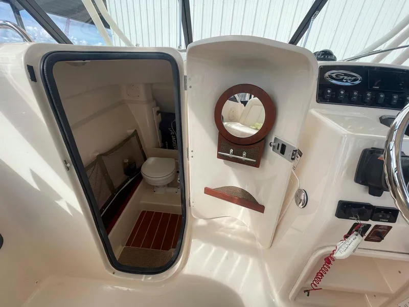 Slide: The Image of 2015 Grady-White Freedom 275 boat interior with cabin and helm features. - 21